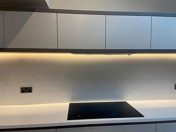 Induction hob and under-cabinet LED lighting in a modern kitchen