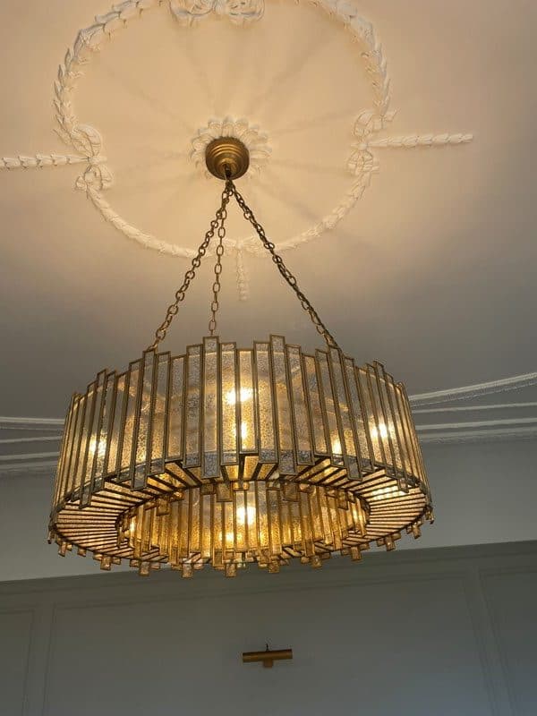 Crystal chandelier installation in a period home
