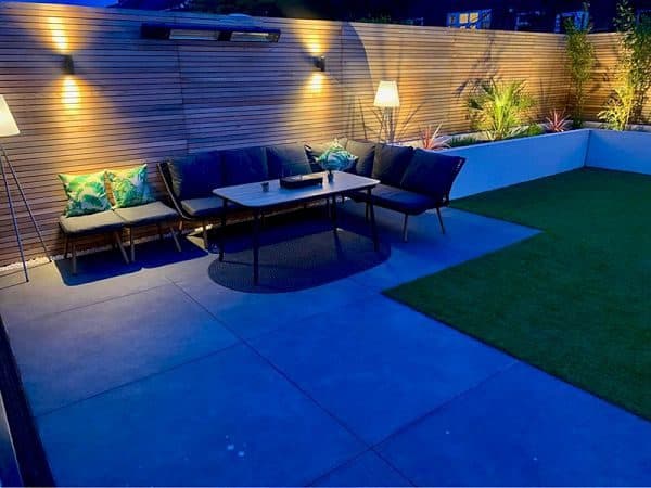 Garden seating area with landscape lighting at dusk